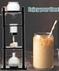 Borosilicate Cold Brew Drip Tower For Iced Coffee Slow Japanese Maker with 35 Oz capacity and iced coffee in a glass.