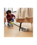 Person using the 18V Brushless Cordless Compact Stick Vacuum Cleaner Bare Tool For Quick Cleanups On The Fly under a bed