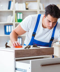 Man installing Premium Plastic Drawer Slide And Guide Replacement Kit With All Necessary Screws for furniture repair.
