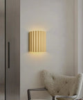 Indoor Hardwired Up and Down Cream Wall Sconce Set of 2 Modern LED 3000K on a wall next to a plush chair.