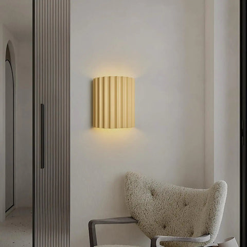 Indoor Hardwired Up and Down Cream Wall Sconce Set of 2 Modern LED 3000K on a wall next to a plush chair.