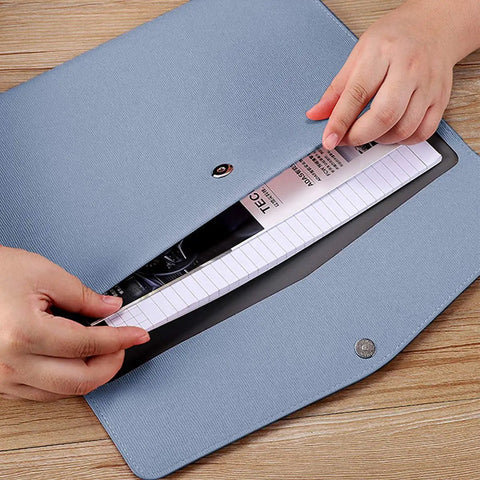 Hands placing papers in blue Durable PU Leather A4 File Folder Waterproof Document Holder With Snap Closure Blue Go To Portable Envelope Folder Case