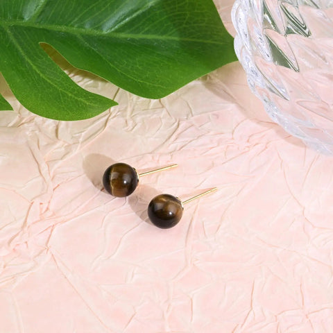 Tiger Eye Stone Stud Earrings 8mm Brown Round Gemstone Jewelry In 14K Gold Plated Finish For Women, pair on pink fabric