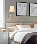 Bedroom scene with 1 Light Wall Sconce With Plug In Or Hardwired Install In Brushed Nickel Finish White Alabaster Fabric Shade Vanity Light
