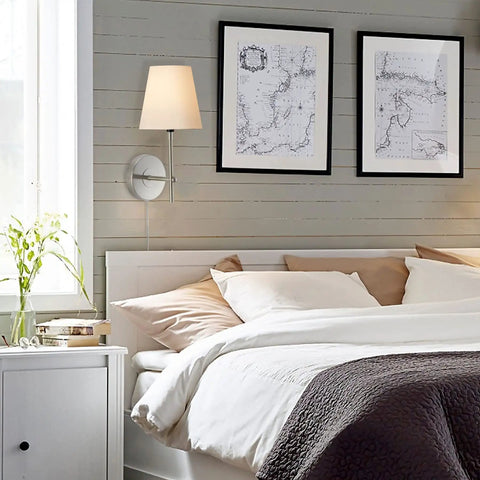 Bedroom scene with 1 Light Wall Sconce With Plug In Or Hardwired Install In Brushed Nickel Finish White Alabaster Fabric Shade Vanity Light