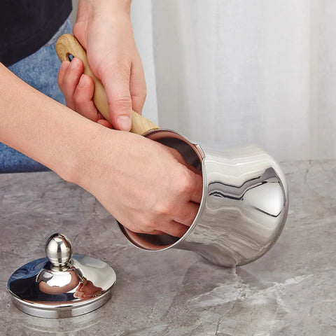 Person handling Turkish Coffee Pot Set 720ml 24oz Stainless Steel Briki Cezve For Turkish Greek Arabic Coffee Maker With Bakelite Handle.
