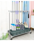 Stainless Steel Mop Holder With Movable Broom Rack And Cleaning Tool Organizer For Commercial Use A Workhorse For Durable Garden Tool Storage And Umbrella Stand Heavy Duty Wall Mount For Garages And Shops showing multiple tools organized neatly.