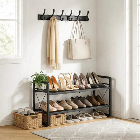Expandable Two Tier Metal Shoe Rack Organizer For Entryway And Closet Adjustable Length From 18.6 To 30.5 Inches Holds Up To 8 Pairs Black Shoe Shelf With Four Hooks For Garage Door Entrance in a room setting with shoes.