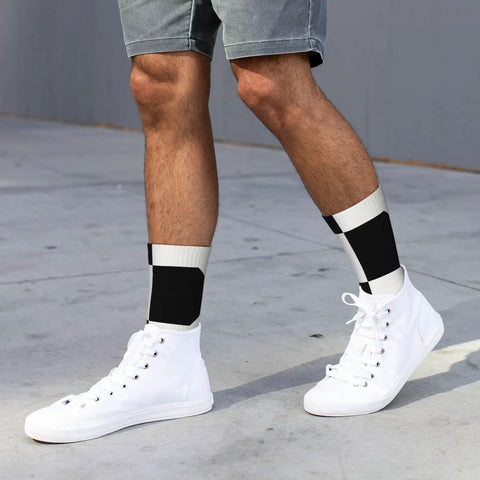 Fresh Black And White Piano Grid Print Crew Socks For Men And Women Straight Up Comfy Polyester Athletic Hosiery worn with white sneakers.