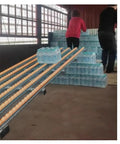 No Sweat Gravity Roller Unloading Ramp With Durable Steel Frame And Smooth ABS Tracks, used for unloading water bottles.