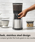 Hand adjusting Barista Grade Conical Burr Electric Coffee Grinder with 12 oz capacity in stainless steel.