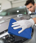 Person using Ultra Absorbent Cotton Shop Towels Pack Of 50 12 By 14 Inches Super Soft Rags For Home Garage And Auto Care Grime Busting.