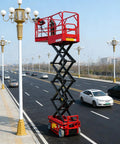 Heavy Duty Electric Hydraulic Lift Platform For Warehouse Vertical Cargo Transfer And Seamless Operation Engineered For Logistics Facilities With Rock Solid High Reach Equipment Handling Built Tough For Daily Grind in use beside a roadway.