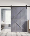 Gray Wood Barn Door Slab 54x84 Inches With 9 Foot Barn Door Hardware Track Kit Included, installed in a modern room