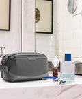 Large Travel Toiletry Organizer For Men With Water Resistant PU Leather Trim in a bathroom setting