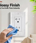 Heavy Duty 20 Amp Tamper Resistant Decorator Outlet Nema 5-20R Residential Receptacle With Self Grounding Terminal UL Certified White Wall Socket being cleaned.