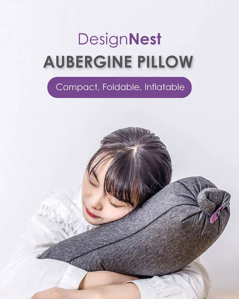 Person hugging Eggplant Inflatable Pillow With Ergonomic Hug Design For Naps And Lounging, grey color, compact design.
