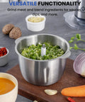 Stainless steel bowl with chopped vegetables for the 6 Cup Mini Food Processor Chopper With 250W Motor And Stainless Steel Blades Plus Meat Grinder Attachment For Meat Veggies Onion Garlic Nuts Sauces Ice And Baby Food In A Compact 1.5L Kitchen Processor on a kitchen counter.