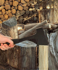 Person using Durable Camping Hatchet Full Tang Axe For Wood Splitting Kindling And Campfire Chops.