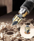 Countersink drill bit, 1/4 in hex shank, gold finish; close-up view in drill chuck with wood shavings