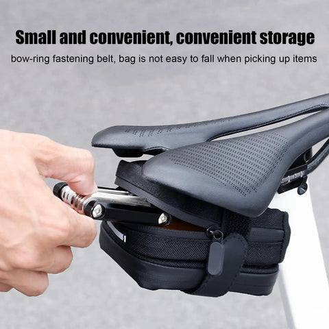 Rear Saddle Bag Organizer for Bike Touring and Bikepacking being accessed under a bicycle seat, showing secure fastening