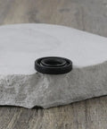 Black nitrile oil seal, 12x24x4.5mm, double-lip rotary shaft seal for industrial equipment.