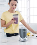 Person holding 24 Ounce Tall Cup With Standard Lip Ring For Personal Blenders On The Go, BPA Free Tritan, Clear With Gray Lip Ring