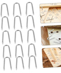 50 Pack U Shaped Fence Staples For Quick Install And Strong Hold Durable Metal Garden Stakes For Fences Landscaping And DIY Projects Multi Function Iron Pegs on wooden surface