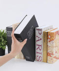 Hand placing extra large 10.5 inch diversion book safe with 3 digit combination lock hidden money safe in plain sight black metal lock box among real books