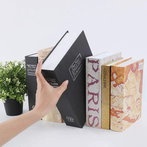 Hand placing extra large 10.5 inch diversion book safe with 3 digit combination lock hidden money safe in plain sight black metal lock box among real books