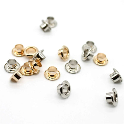 Must Have Reinforced Grommet Kit Set For DIY Projects 200 Pieces With 3 By 16 Inch Brass Eyelets scattered on white surface