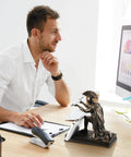Office desk with Knight Pen Holder Desk Organizer Resin With 2 Pens next to a man working on a computer, adding decor and utility.