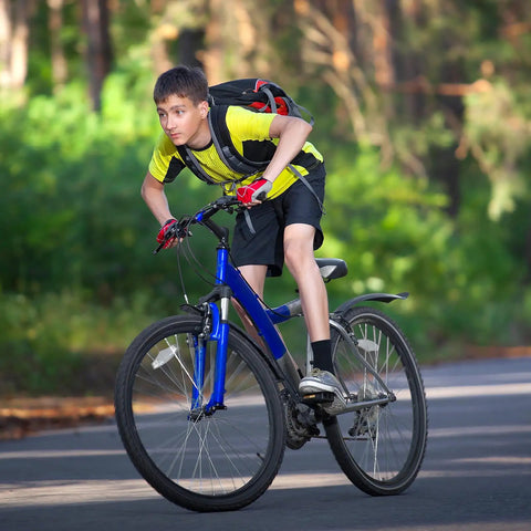 Young cyclist rides bike with Heavy Duty 24x1 3/8 Inner Tubes 37-540 With AV32mm Schrader Valve Two Pack Built To Take A Beating