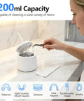 Clean clear aligners in 200ml ultrasonic retainer cleaner, showcasing user with metal tool, modern bathroom setting.