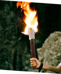 Person holding traditional lit tiki torch with braiding, resembling Outdoor Solar Tiki Torch Light For Garden Fence Decoration