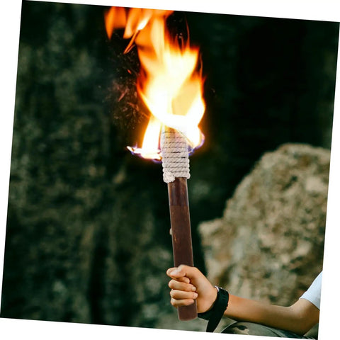 Person holding traditional lit tiki torch with braiding, resembling Outdoor Solar Tiki Torch Light For Garden Fence Decoration