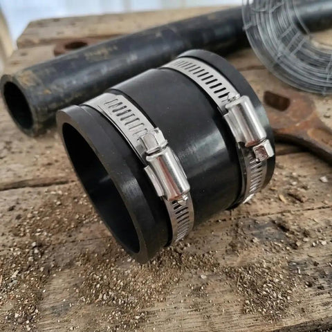 Top Notch Flexible Pipe Coupling Kit For 1 Inch PVC And Rubber Drain Repair Clamps Fast Fix For Leaky Sewer Lines Easy Install Plumbing Connection black hose coupling with stainless steel clamps on workbench