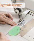Green Upgraded Magnetic Seam Guide for Sewing Machines with Polygonal Design, placed next to fabric on a sewing machine.