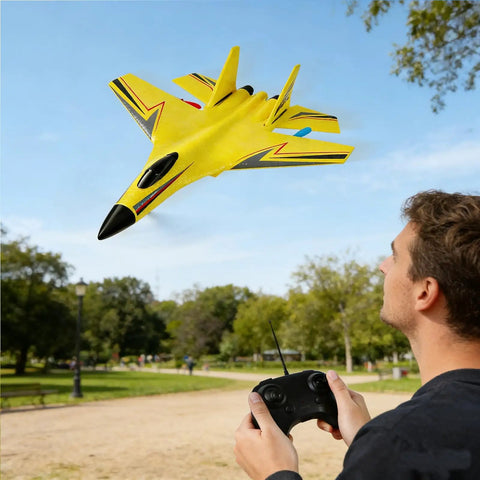 Man flying yellow foam remote control plane in park, illustrating Easy To Fly Foam Remote Control Airplane For Beginners And Adults.