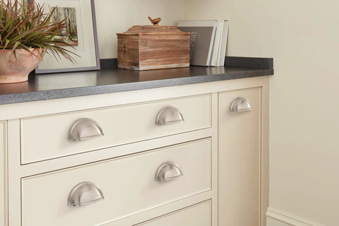 Traditional Cup Pull Cabinet Handle in Satin Nickel, 3 Inch Center-to-Center, installed on white drawers in modern kitchen setting.