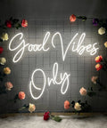 Good Vibes Only Neon Sign For Walls Large LED Neon Light For Bedroom Party Bar Café Shop Decor Warm White 56 By 13 Inches glowing on grid wall with roses