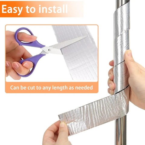 Hands cutting and applying Beefed Up Heavy Duty Pipe Insulation Wrap 2 Inch By 33 Foot Self Adhesive Aluminum Foil to a pipe.