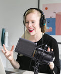 Person using Mic Shock Mount With Pop Filter For 46mm To 51mm Condenser Microphones during a podcast