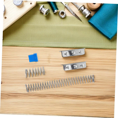 Fabric Cutting Fixture Flat Spring Holder Five Piece Pro Grade Set for Sewing Machines, springs and holders on table