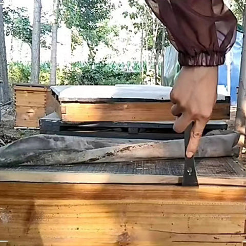 3 In 1 Stainless Steel Bee Hive Tool With J Hook And Box Scraper Knife For Lifting Frames Beekeeping Gear in use on a beehive