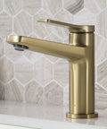Indy Single Handle Basin Bathroom Faucet With Pop Up Drain And Overflow in Brushed Gold Solid Brass on white counter