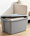 Kickass 30 Gallon Heavy Duty Plastic Storage Bin With Secure Snap Lid For Garage Organization Seasonal Gear Sorting And Everyday Essentials In Matte Gray Finish with towels inside.