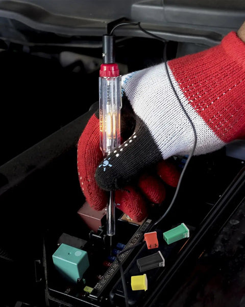 Person using a diagnostic tool on a car's electrical fuse box showcasing 48 Piece Tall And Low Profile Automotive Blade Fuse Assortment Kit With Puller Includes 20A 30A 40A 50A 60A 80A For Cars Trucks SUVs Boats UTVs ATVs And More Go To Fuse Kit