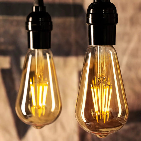 Two Six Pack Vintage Style LED Edison Light Bulbs, 6W Realistic Filament, 60W Equivalent, hanging with warm glow, black finish.