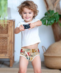 Fresh Duds Cotton Boys Briefs Featuring Classic Rickshaw Mobile Graphics For Active Toddler Guys worn by a smiling boy with a camera.